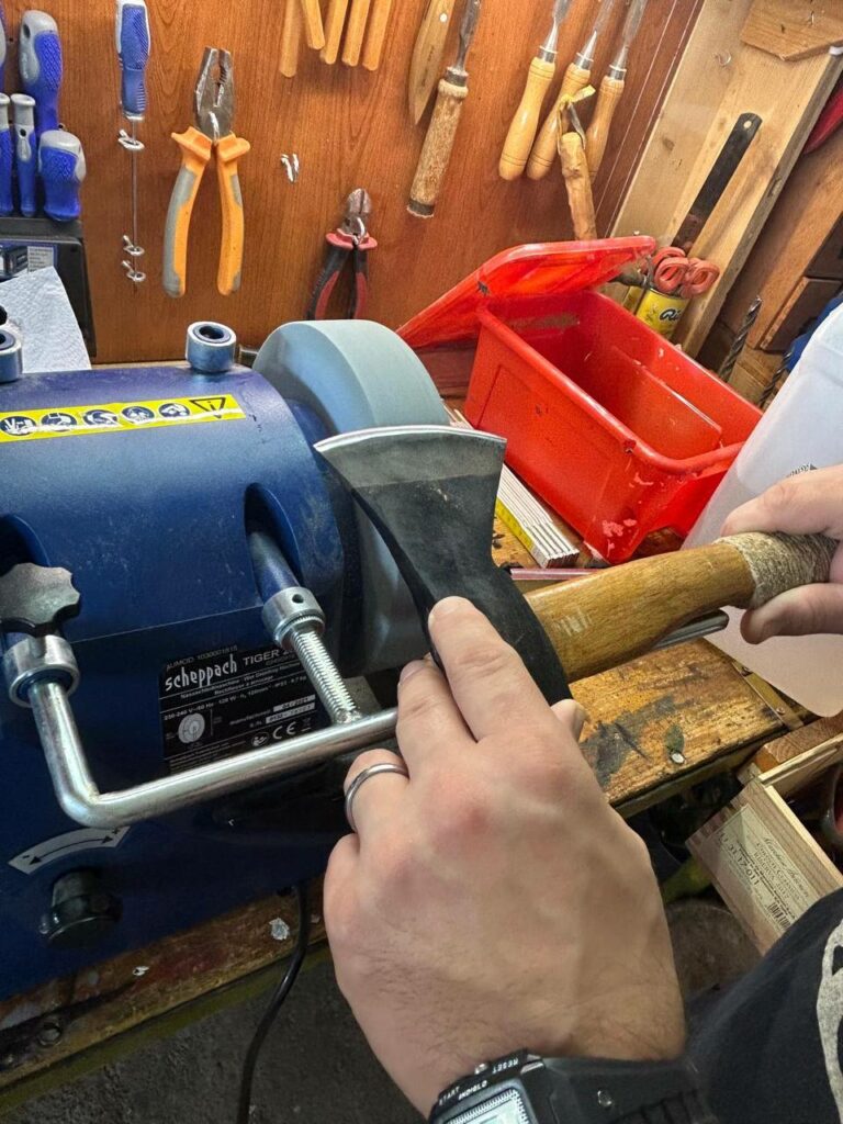 Sharpening Carving Knives and Woodworking Tools: Complete Guide! - post showing the jig at work on a grinding wheel