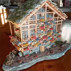 Handcrafted miniature of a Valdostan house made of wood and soapstone by an artist from the Sant’Orso Fair